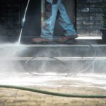 Professional cleaning stairs with a pressure washer.